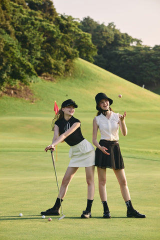 FAIRLIAR 26SS editorial - two coordinated golf outfits in black and white on the course